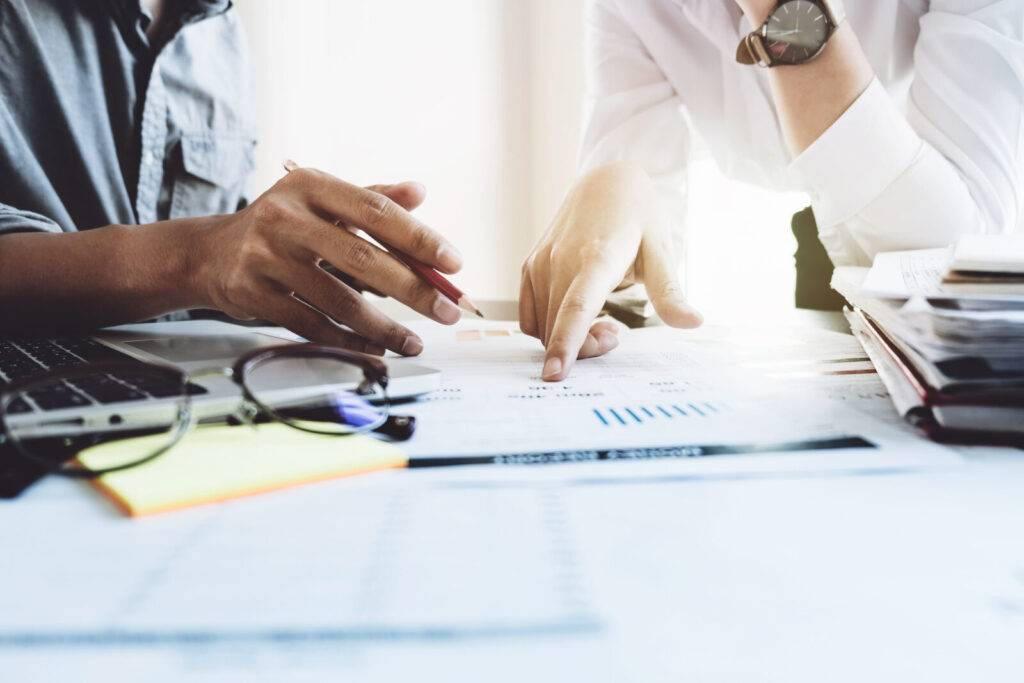 Two people looking at charts